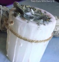 White Pillar candle with sage on top