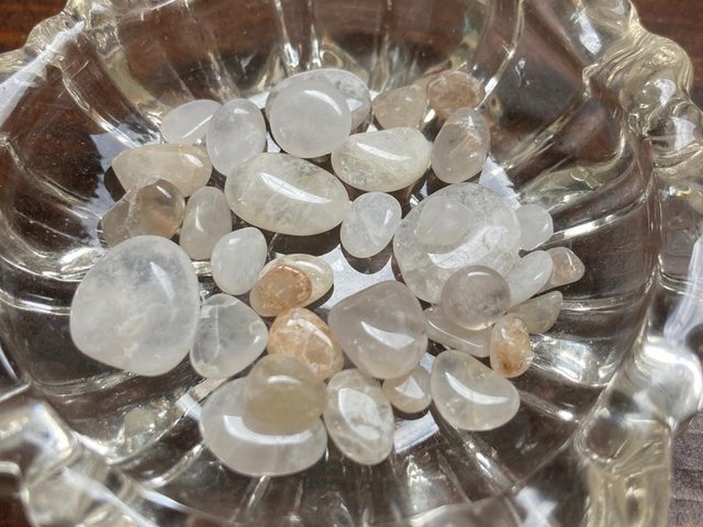 clear quartz crystals in a glass bowl